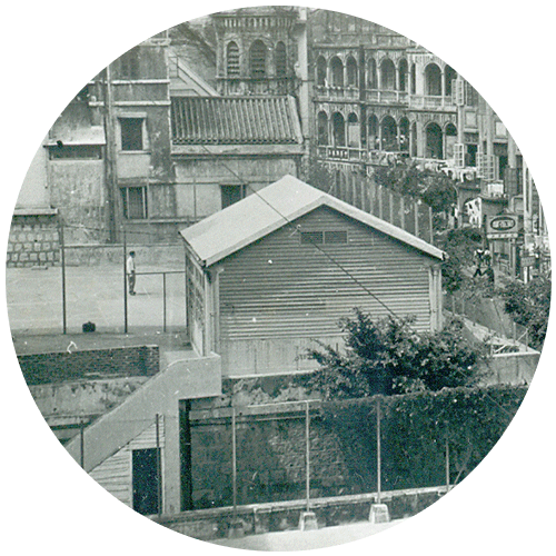 Handwork Room(Small hut) and Residential buildings on Pokfulam Road(Buildings on the right)